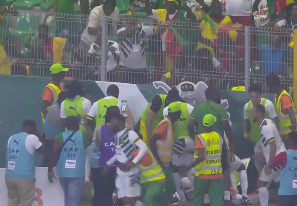 Cameroon players and fans pictured celebrating a late goal during a 3-2 win over Gambia at the Africa Cup of Nations in January 2024